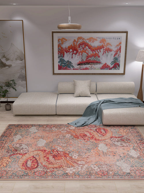 Bild 1 in Galerieansicht laden. A modern living room with a beige sectional sofa, gray throw blanket, and the Blazefang Myth Washable Rug (JR0049) in red with a subtle geometric pattern. White walls feature a large landscape painting and tall floor lamp; a plant sits by the sofa.