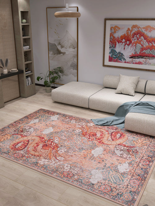 Bild 1 in Galerieansicht laden. A modern living room with a light sectional, the Blazefang Myth - Washable Rug - JR0049 featuring a vibrant red and orange dragon, beige flat weave, wall art of colorful mountains, potted plants, and wooden decor shelves.