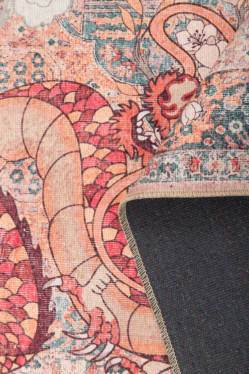 Bild 1 in Galerieansicht laden. A close-up of the Blazefang Myth - Washable Rug - JR0049 shows its vivid dragon design in red, orange, and beige. One corner is flipped to display the dark blue underside and stitched edge.