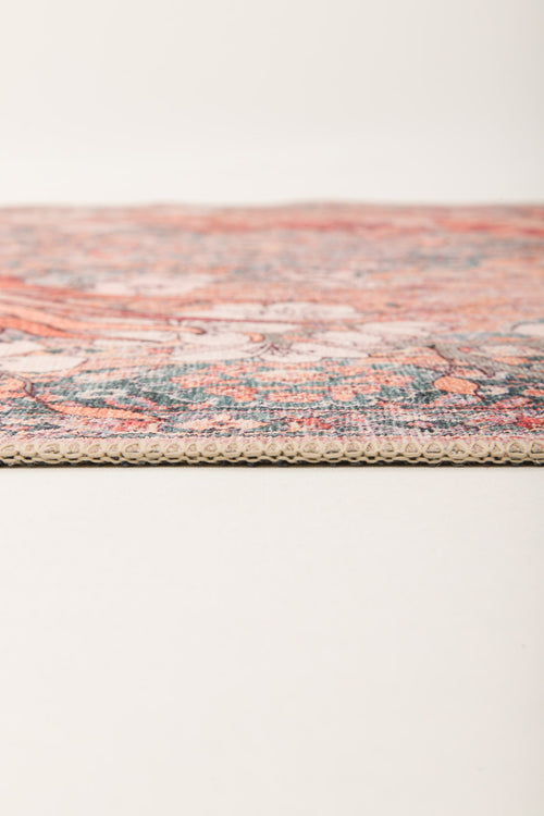 Bild 1 in Galerieansicht laden. Close-up side view of the Blazefang Myth - Washable Rug (JR0049) featuring a thin, flat weave with a textured edge and vibrant geometric pattern, displayed on a plain light surface against a neutral background.