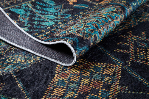 Load image 1 in gallery view. A close-up of the Blossoming Bazaar - Washable Rug - JR1862 (Custom Size) shows its dark, teal, gold, and brown patterns. A folded corner reveals the detailed front and textured underside—perfect for high-traffic spaces.