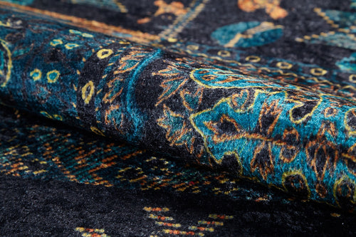 Load image 1 in gallery view. A close-up of the Blossoming Bazaar - Washable Rug - JR1862 (Custom Size) reveals intricate teal, yellow, and orange patterns on dark blue, highlighting its rich texture—ideal for high-traffic areas and easy to clean.