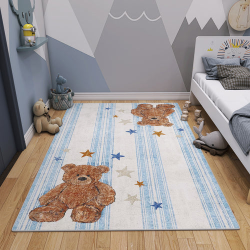 Load image 1 in gallery view. White and blue striped rug with teddy bear and star motifs, styled in a children's bedroom.