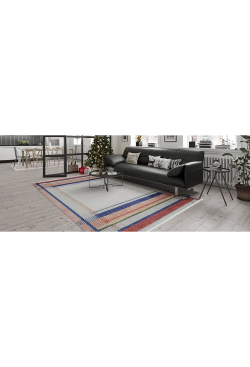 Load image 1 in gallery view. A modern living room featuring a black sofa, Bohemian Nightscape - Washable Rug - JR1701 in red, a coffee table, a decorated Christmas tree by the window, indoor plants, and a bright dining area—ideal for high-traffic spaces.