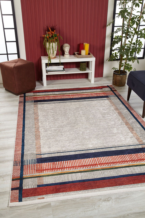 Load image 1 in gallery view. A modern living room with the Bohemian Nightscape - Washable Rug - JR1701 (Custom Size) featuring geometric patterns, a white console, decor accents, a potted plant, brown ottoman, blue chair, and red accent wall—ideal for high-traffic areas.