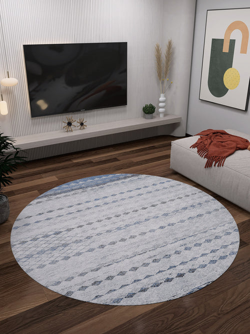 Bild 1 in Galerieansicht laden. A modern living room with the Bohemian Reverie - Washable Rug - JR1974 in gray-anthracite on wooden floors, a wall-mounted TV, abstract art, plants, and a beige couch with an orange throw—ideal for high-traffic areas.