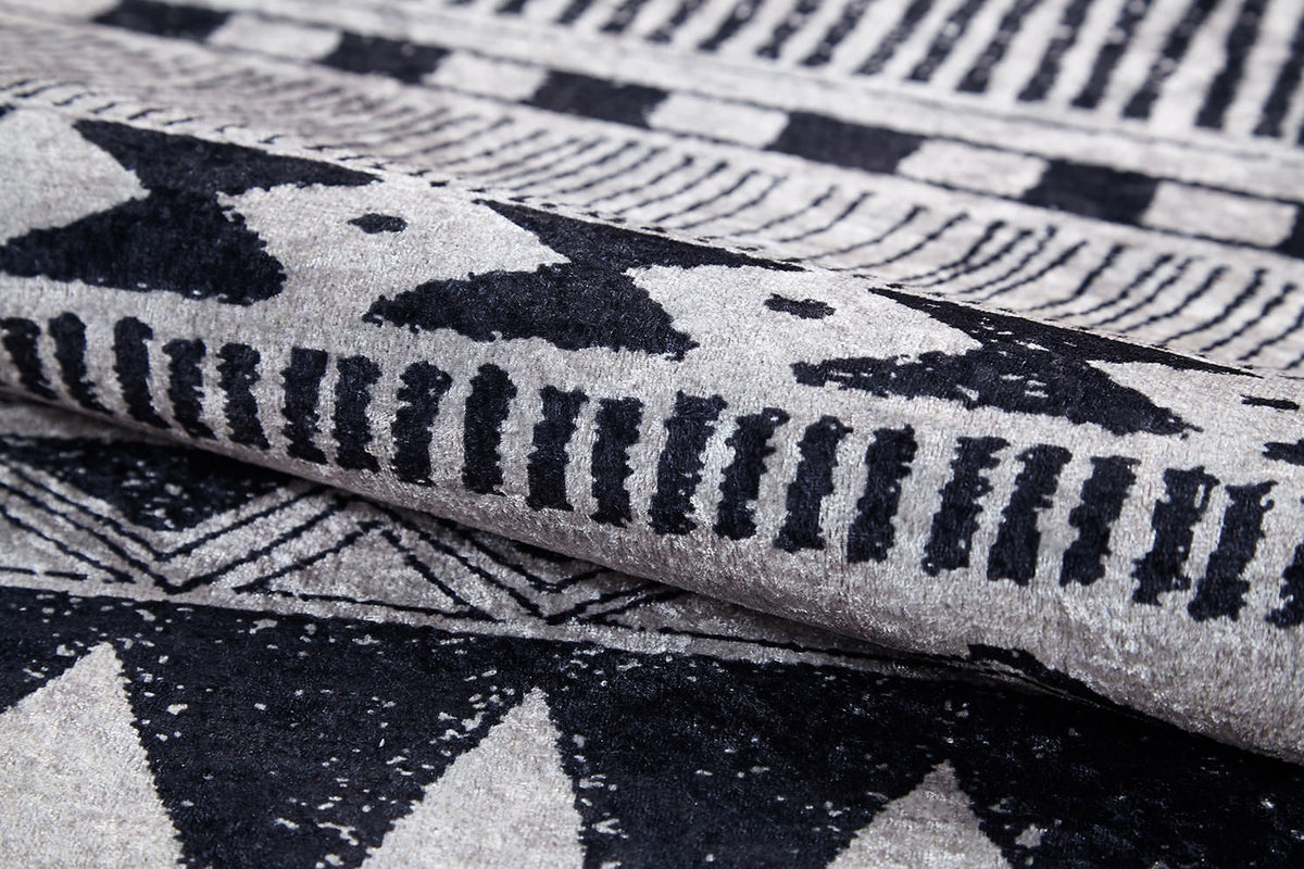 Close-up of the Bohemian Sunrise - Washable Rug - JR1713 (Custom Size), showcasing its bold black and white geometric patterns—triangles, lines, and dots—perfect for adding texture and style to high-traffic areas.