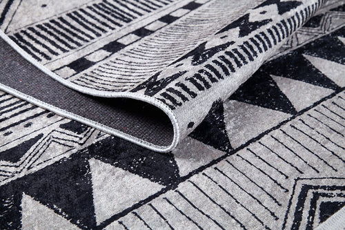 Load image 1 in gallery view. A close-up of Bohemian Sunrise - Washable Rug - JR1713 (Custom Size), folded to show black and gray triangles, stripes, and geometric patterns—ideal as a washable rug for high-traffic areas.