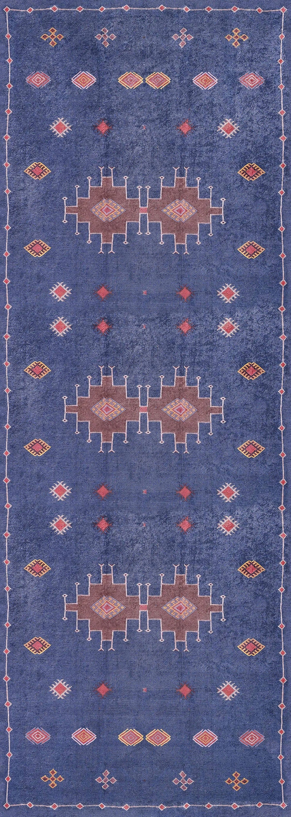 The Boho Chic Tapestry - Washable Rug - JR5083 is a rectangular blue rug with geometric patterns in white, red, orange, and pink. It features three central medallions, smaller shapes, and a simple border in a symmetrical design.