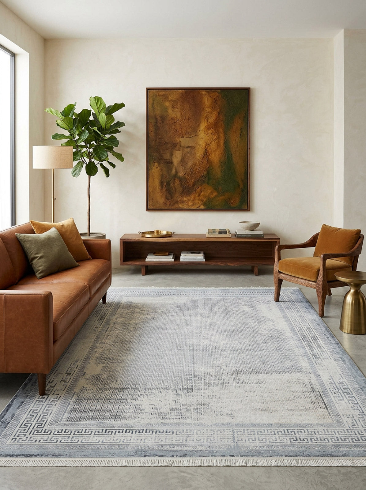 Blue and cream distressed rug with a Greek key border, styled in a modern living room.