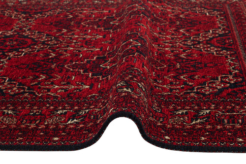 Load image 1 in gallery view. A close-up of the Bold Thread - Kilim - BHR05 rug, featuring an intricate red, black, and beige Turkish pattern with a visible ripple running through the center.