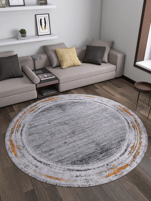 Load image 1 in gallery view. A modern living room with beige sectional sofas, accent pillows, wooden flooring, a small side table, shelves on a white wall, and the Bold and Chic - Washable Rug - JR1198 in gray, white, and orange—ideal for allergy-sensitive spaces.