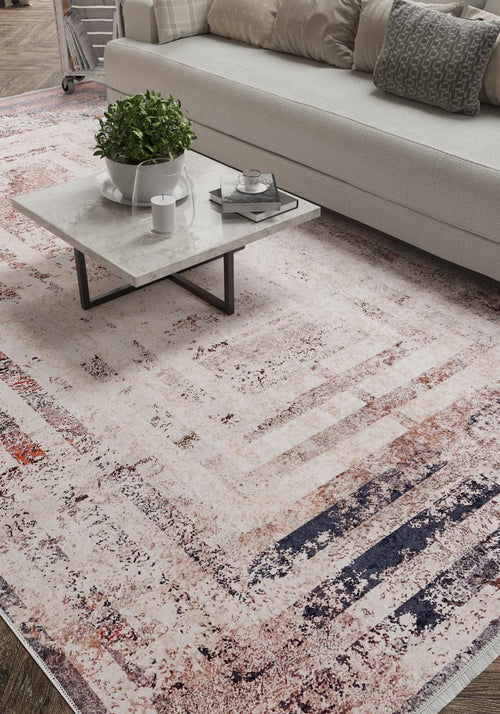 Load image 1 in gallery view. A modern living room features the Bold and Geometric - Washable Rug - JR1410, perfect for high-traffic areas, a square marble coffee table with a plant and cup, and a beige sofa accented by textured pillows in the background.
