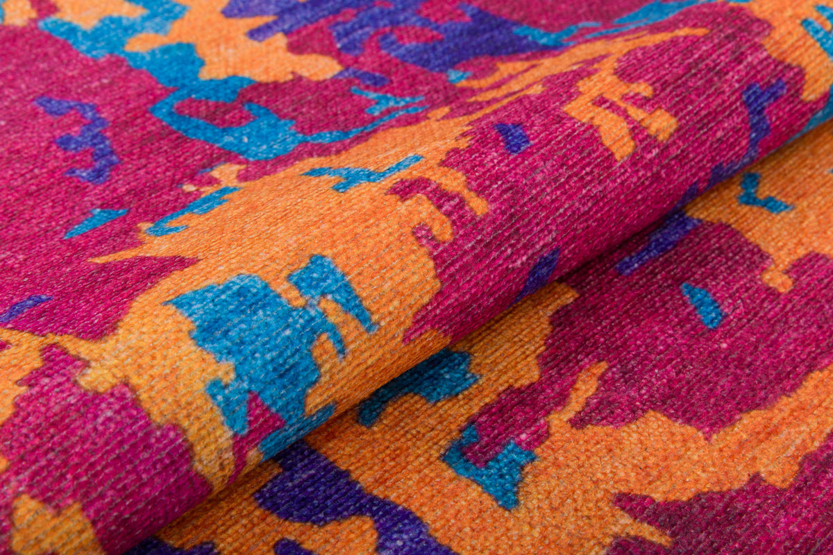 A close-up of the Celestial Tapestry - Washable Rug - JRS004 (Custom Size) showcases its vibrant abstract pattern in orange, magenta, blue, and purple—highlighting colorful shapes and textured weave, ideal for high-traffic areas.