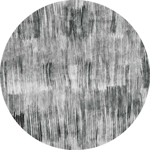 Load image 1 in gallery view. Round black and white rug with a distressed, vertical brushstroke pattern.