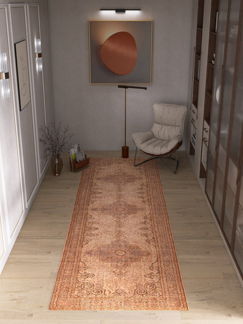 Bild 1 in Galerieansicht laden. A modern hallway with the Chateau Elegance - Washable Rug - JRN1018 in orange, a white cushioned chair, tall floor lamp, round minimalist wall art, right-side shelving, and a vase of branches on the left.