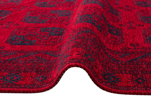 Load image 1 in gallery view. A close-up of the Cherry Texture - Washable Kilim - BHR01, featuring detailed red and dark blue geometric designs and texture with a wave-like fold, shown against a white background.