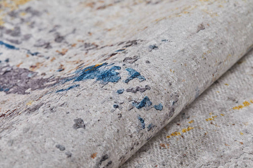 Load image 1 in gallery view. A close-up of the Chromatic Kaleidoscope - Washable Rug - JR1483 (Custom Size) shows its textured, abstract design with blue, yellow, and brown splashes on a light gray background—ideal for high-traffic areas.