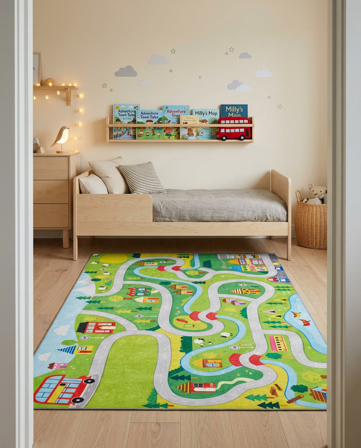 Green rug featuring a winding road, buildings, and trees, styled in a child's bedroom.