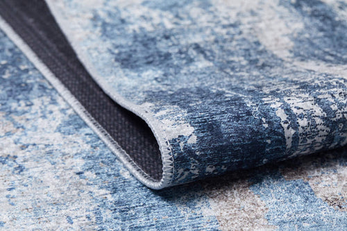 Load image 1 in gallery view. A close-up of the Classic Bordered - Washable Rug - JR1197 (Custom Size) in blue and white, featuring a folded corner to display its stitched edge, patterned top, and dark, non-slip backing—ideal for allergy-sensitive or busy homes.