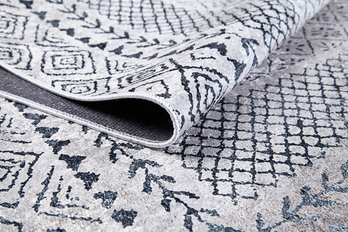 Load image 1 in gallery view. A close-up of the Classic Contrast - Washable Rug - JR1985 (Custom Size) in gray-anthracite, featuring a folded corner that highlights its flat weave texture and intricate geometric and floral patterns on both sides.