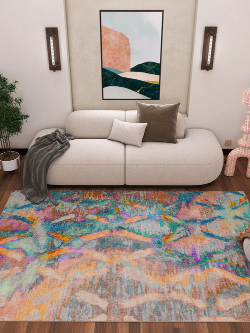Bild 1 in Galerieansicht laden. A modern living room with a curved white sofa, neutral cushions, gray throw, and the Classic Motif - Washable Rug - JRN29 featuring colorful geometric patterns—ideal for high-traffic areas. Green plant, wall sconces, and abstract art complete the space.