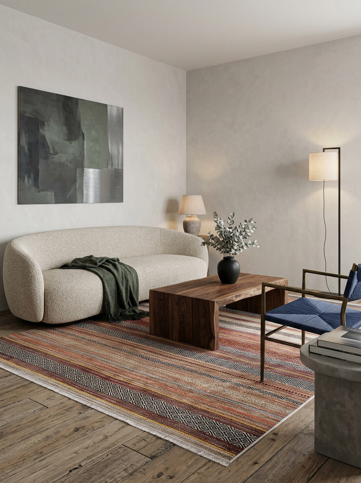 Multi-colored striped rug with geometric diamond borders, styled in a modern living room with a cream sofa.