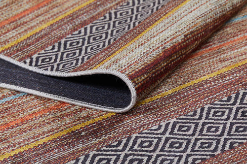 Load image 1 in gallery view. Close-up of the Coastal Breeze - Washable Rug - JR1549 (Custom Size), featuring colorful stripes, geometric diamonds, a textured surface, and a folded corner showing the back—ideal for high-traffic spaces.