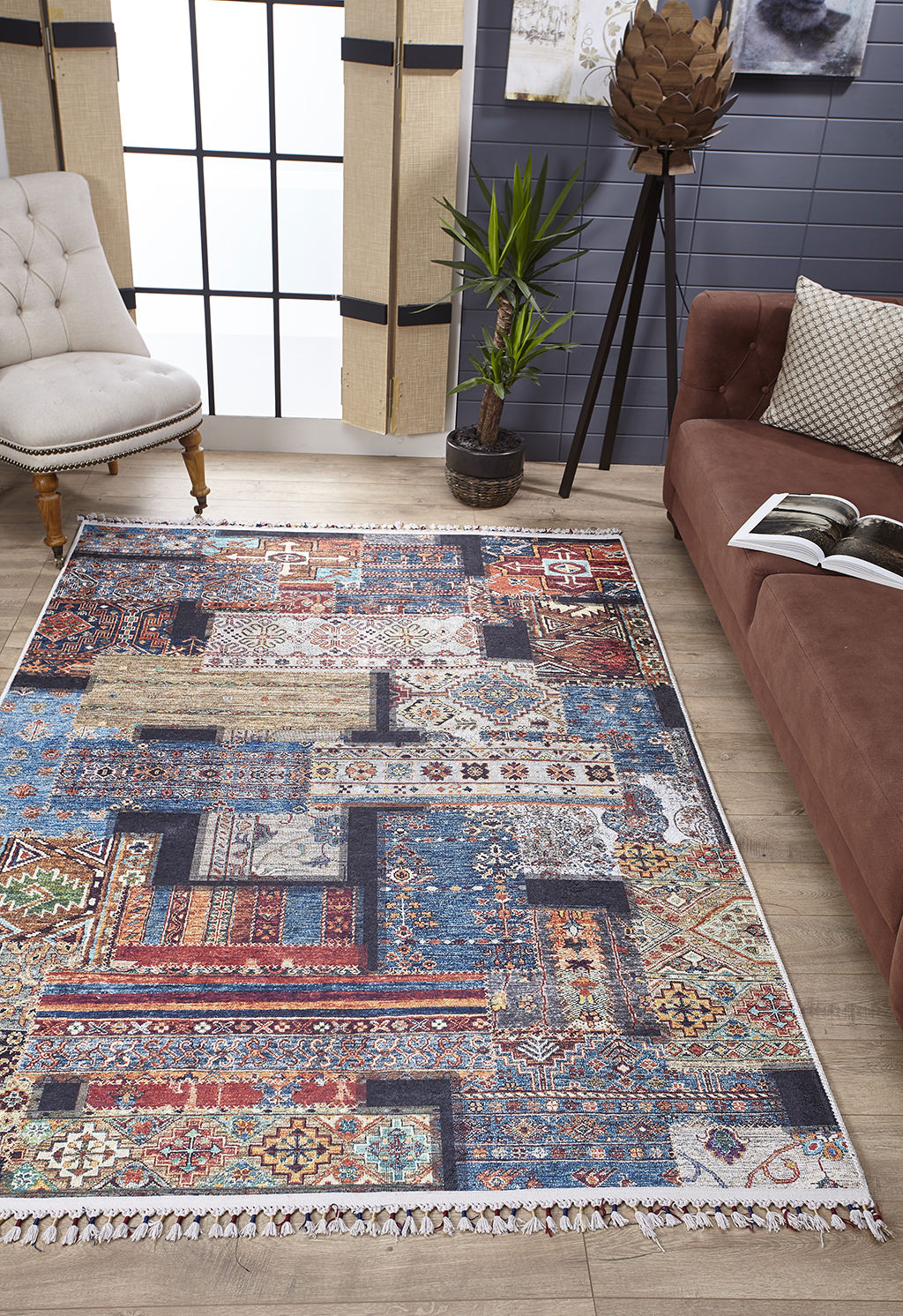 The Colorful Composition - Washable Rug - JR5107 (Custom Size) showcases geometric and floral patterns in a modern living room with wood floors, tan chair, brown sofa, potted plant, and large window—ideal for busy spaces.