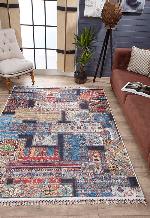 Load image 1 in gallery view. The Colorful Composition - Washable Rug - JR5107 (Custom Size) showcases geometric and floral patterns in a modern living room with wood floors, tan chair, brown sofa, potted plant, and large window—ideal for busy spaces.