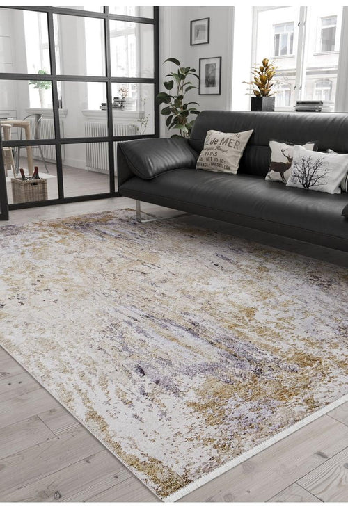 Load image 1 in gallery view. Modern living room with a black sofa, decorative pillows, plants, and city views through large windows. The 'Contemporary Canvas - Washable Rug - JR145' in beige and purple highlights the wooden floors; ideal for high-traffic areas with a glass divider.