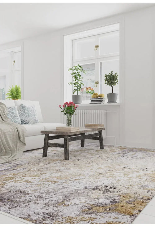 Load image 1 in gallery view. A bright living room features a white sofa, patterned pillows, and a rustic coffee table atop the Contemporary Canvas - Washable Rug - JR145—perfect for high-traffic spaces. Books, flowers, and plants add charm as sunlight pours through large windows.