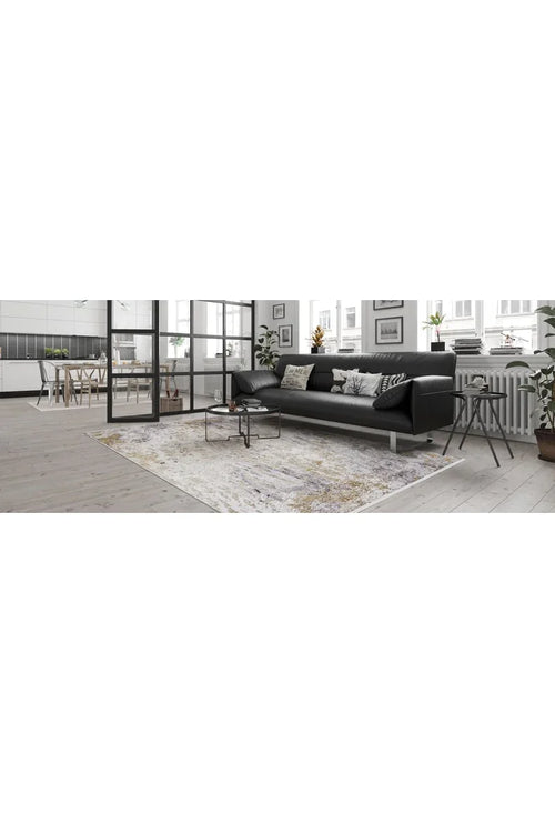 Load image 1 in gallery view. A modern living room features a black sectional sofa, patterned cushions, and the Contemporary Canvas - Washable Rug - JR145—ideal for high-traffic areas. Glass doors lead to the dining area and kitchen, with large windows bringing in natural light.