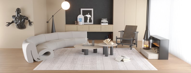 A modern living room features a curved gray sofa, coffee tables, geometric chair, and fireplace. The Contemporary Coordinates - Washable Rug - JR750 (Outlet) US in cream and beige adds comfort and style to this neutral, high-traffic space.