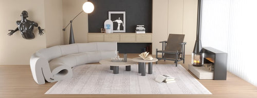 Load image 1 in gallery view. Modern living room with a curved gray sofa, sculptural wall art, coffee tables, and an armchair. The space is anchored by the Contemporary Coordinates - Washable Rug - JR750 (Custom Size) in cream and beige against a dark accent wall.