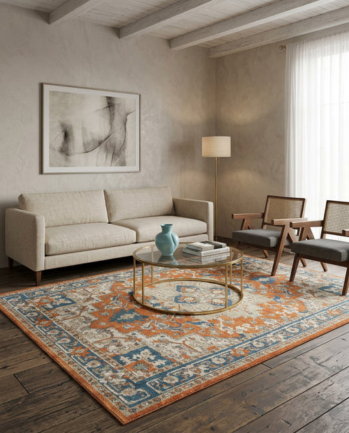 Load image 1 in gallery view. Distressed orange and blue traditional medallion rug in a modern living room setting.