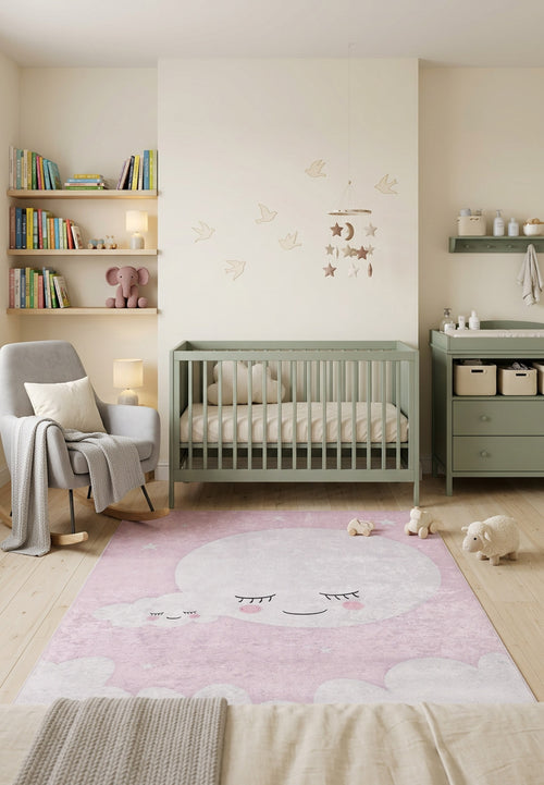 Load image 1 in gallery view. Pink rug with a sleeping moon and cloud pattern, styled in a nursery.