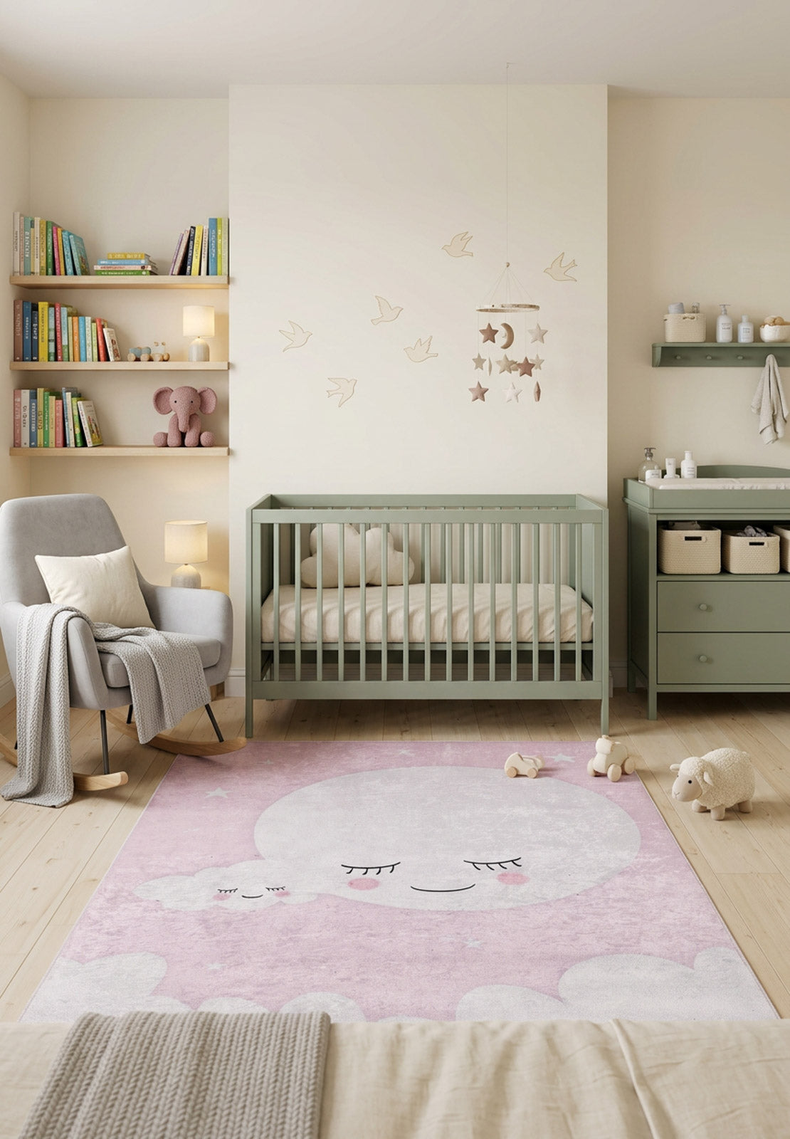 Pink rug with a white sleeping moon and cloud pattern, styled in a nursery.