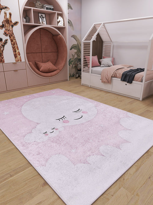 Load image 1 in gallery view. A cozy kids’ room with pink and white decor features a round reading nook, house-shaped bed, giraffe wall art, and the Cosmic Naptime - Machine-Washable Rug JRC032 in soft pink with a sleeping moon and cloud design.