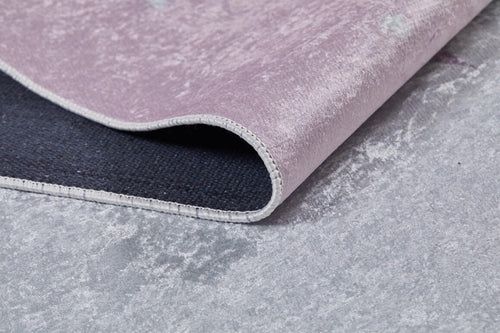 Load image 1 in gallery view. A close-up of the Cosmic Naptime - Machine-Washable Rug JRC032 (Custom Size) in light purple shows its corner lifted to reveal a dark non-slip backing, with the flat weave rug placed on a light gray textured floor.
