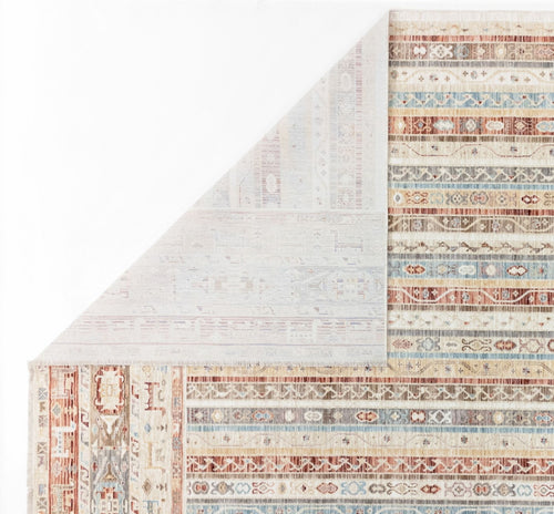 Load image 1 in gallery view. Multi-colored striped rug with geometric patterns in rust, blue, and cream, shown with a corner folded over.
