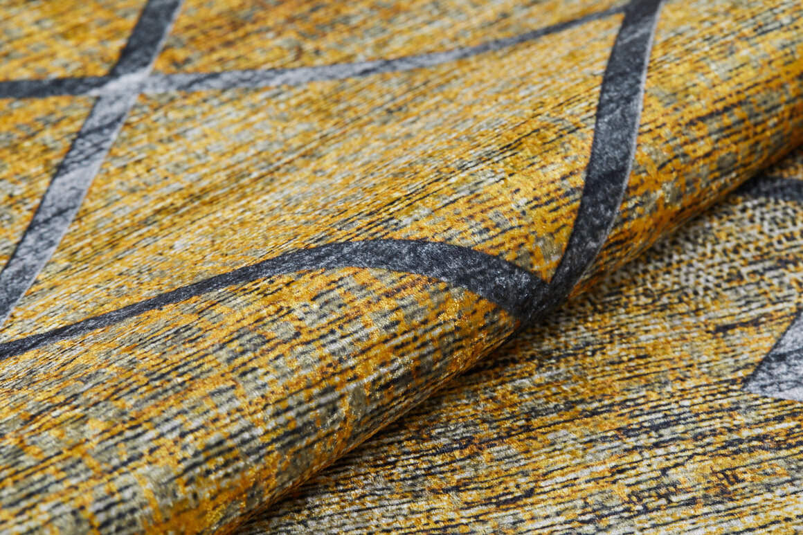 Close-up of the Crossed Connections - Washable Rug - JR1181 (Custom Size), featuring a textured yellow and gray surface with mottled patterns and intersecting dark lines—washable, durable, and ideal for high-traffic areas; fabric shown slightly folded in front.