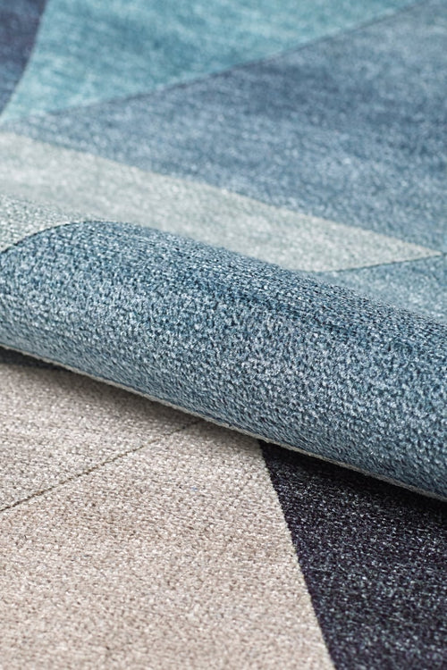 Load image 1 in gallery view. Close-up of the Cubism Collage Blue Washable Rug - MDJ008 (Custom Size), folded to showcase its geometric pattern in blue, gray, and beige tones with a textured surface—perfect for high-traffic areas.