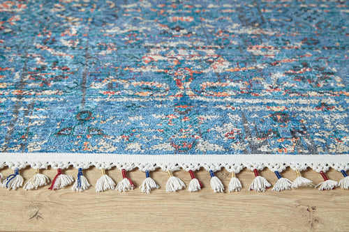 Load image 1 in gallery view. A close-up of the Desert Diamond - Washable Rug - JR5071 (Custom Size) in blue, with multicolored tassels and intricate blue, white, and red designs on a light wood floor—perfect for high-traffic areas.