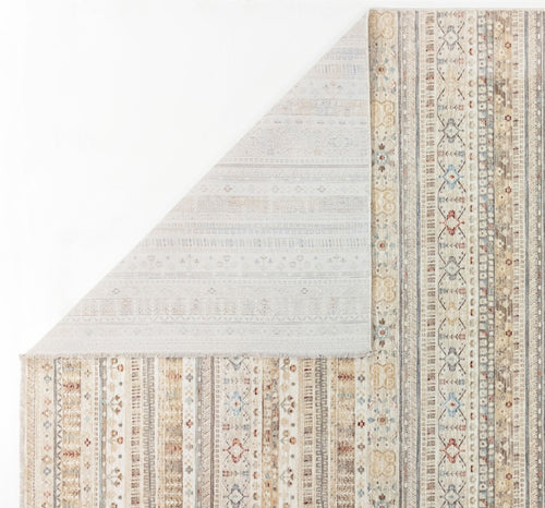 Load image 1 in gallery view. Beige and grey area rug with vertical striped patterns, floral motifs, and a folded corner revealing the light backing.