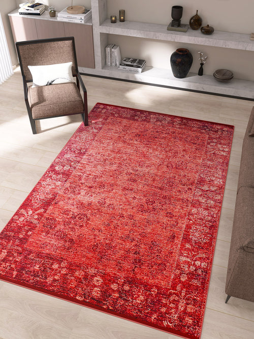 Load image 1 in gallery view. The Dynasty Dream - Washable Rug - JR160 (Custom Size), featuring an oriental pattern in red, lies on a light wood floor in a modern living room with a brown armchair, gray sofa, and shelves holding decorative objects and books.