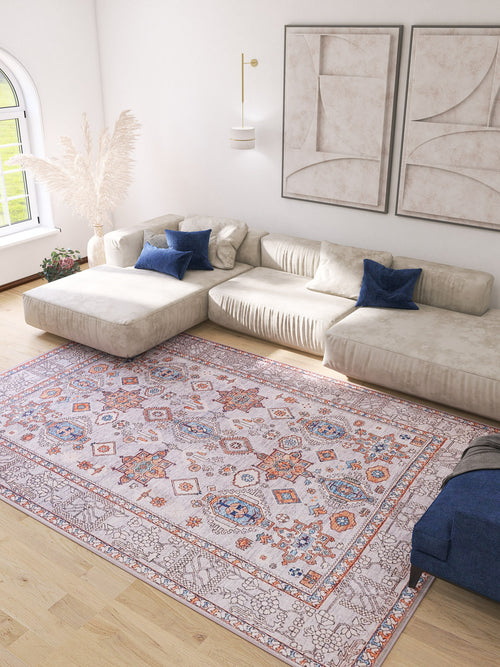 Load image 1 in gallery view. A bright living room with a light beige sectional sofa, blue accent pillows, abstract wall art, a large vase with pampas grass, and the Echelon Bordered Washable Rug - LCC3018 on light wood floors—ideal for high-traffic areas. Sunlight streams in.