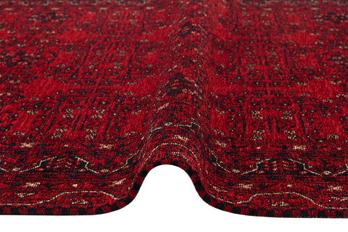 Load image 1 in gallery view. A close-up of the Ember Stitch - Washable Kilim - BHR02 shows its red surface with intricate black and white geometric patterns and borders, featuring a gentle wave or crease through the center.