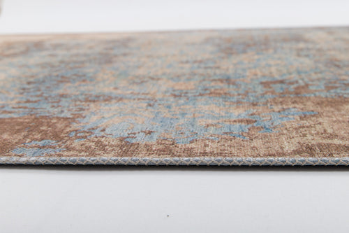 Load image 1 in gallery view. A close-up side view of the Enchanted Threads - Washable Rug - JRS002 (Outlet) US shows its flat weave, faded blue and brown pattern, detailed edge, and stitching, all displayed on a white background.