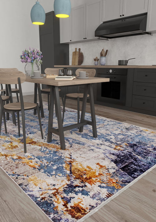 Load image 1 in gallery view. A modern kitchen with light wood floors, black lower cabinets, and a dining table for four features the Enigmatic Elegance - Washable Rug - JR787 in blue, paired with two blue pendants and a vase of flowers—a vibrant, practical choice for high-traffic areas.